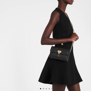 Authentic Louis Vuitton Vavin Chain Wallet in black. Monogram Empreinte Leather.